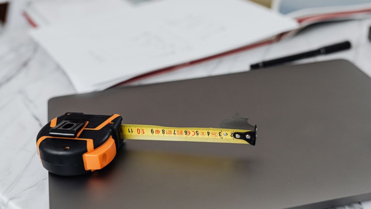 A tangled measuring tape on a desk.