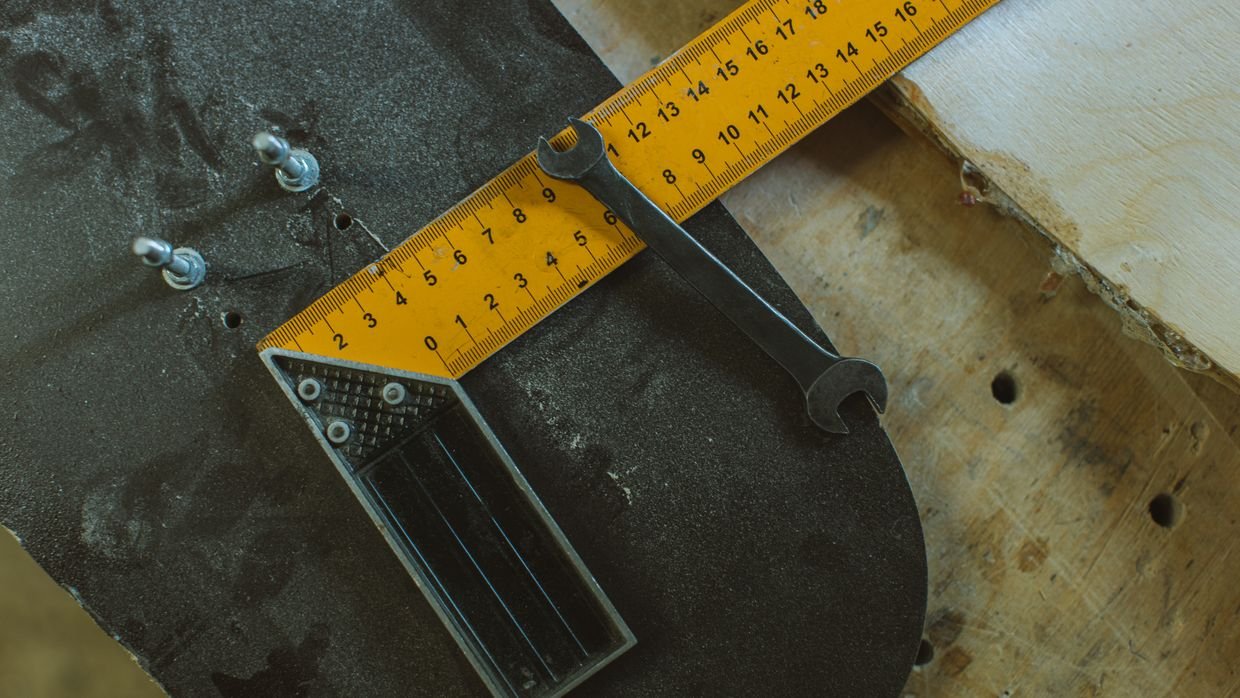 A broken ruler lying on a workbench.
