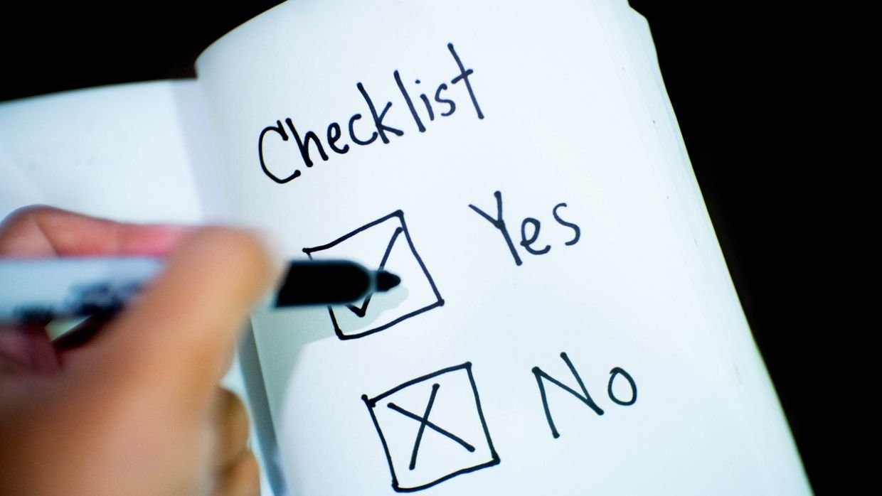 A checklist being ticked off with a pen.