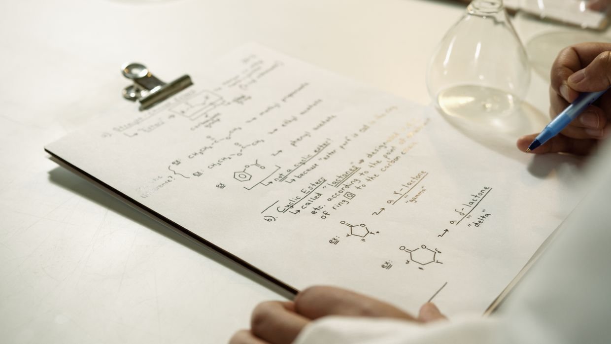 A clipboard holding handwritten results.