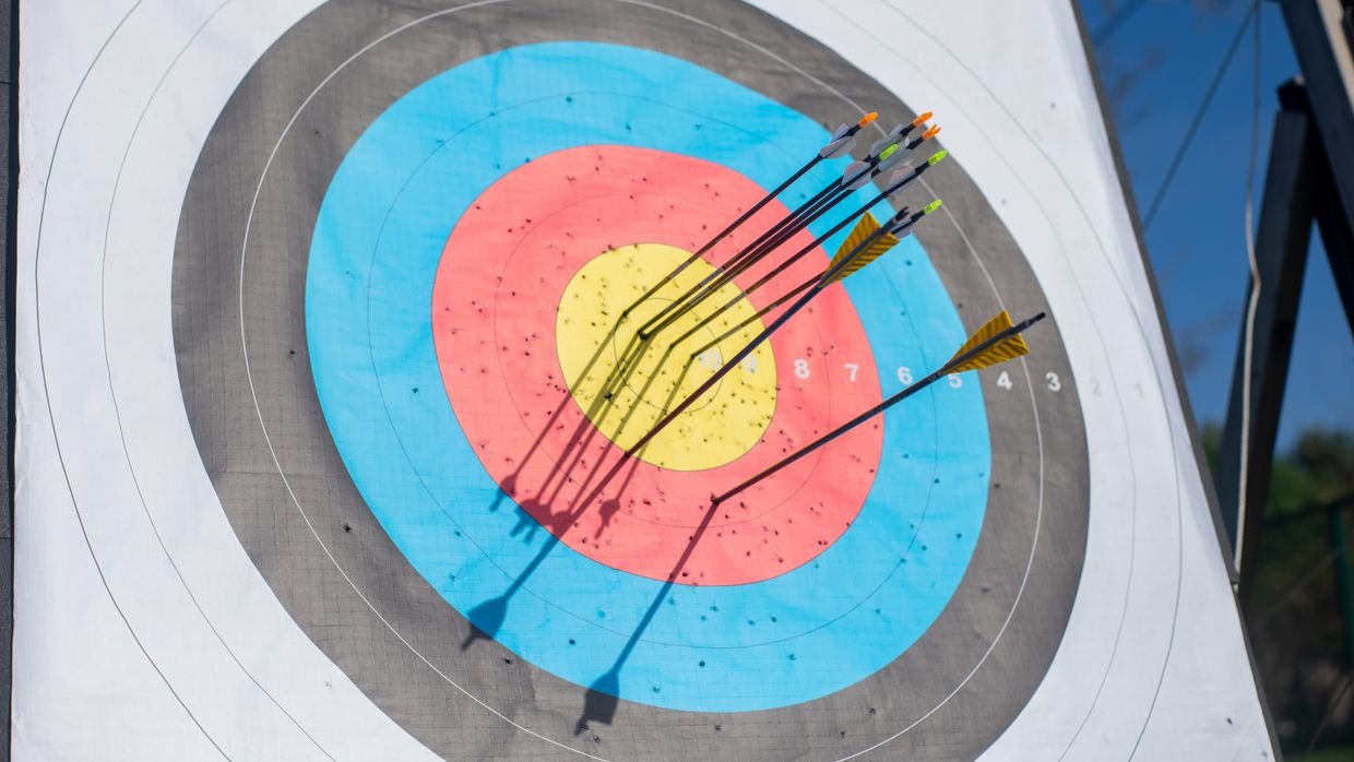 An archery target with arrows in it.