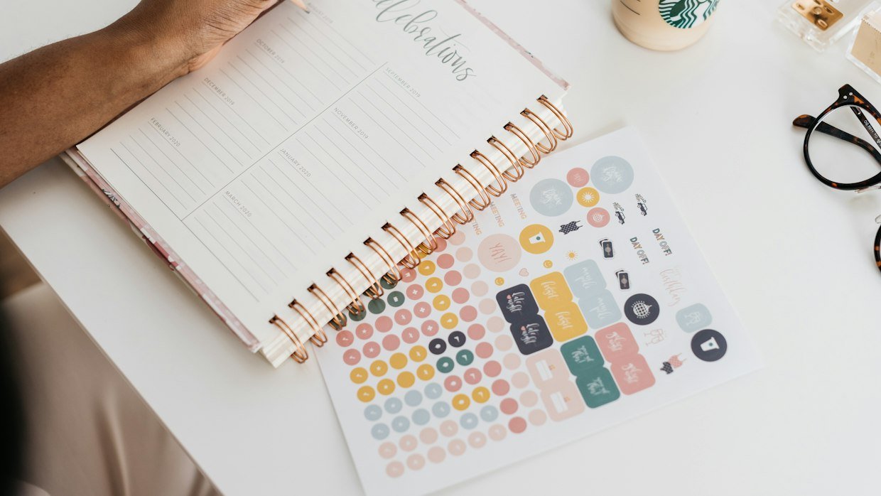 A daily planner open on a desk.
