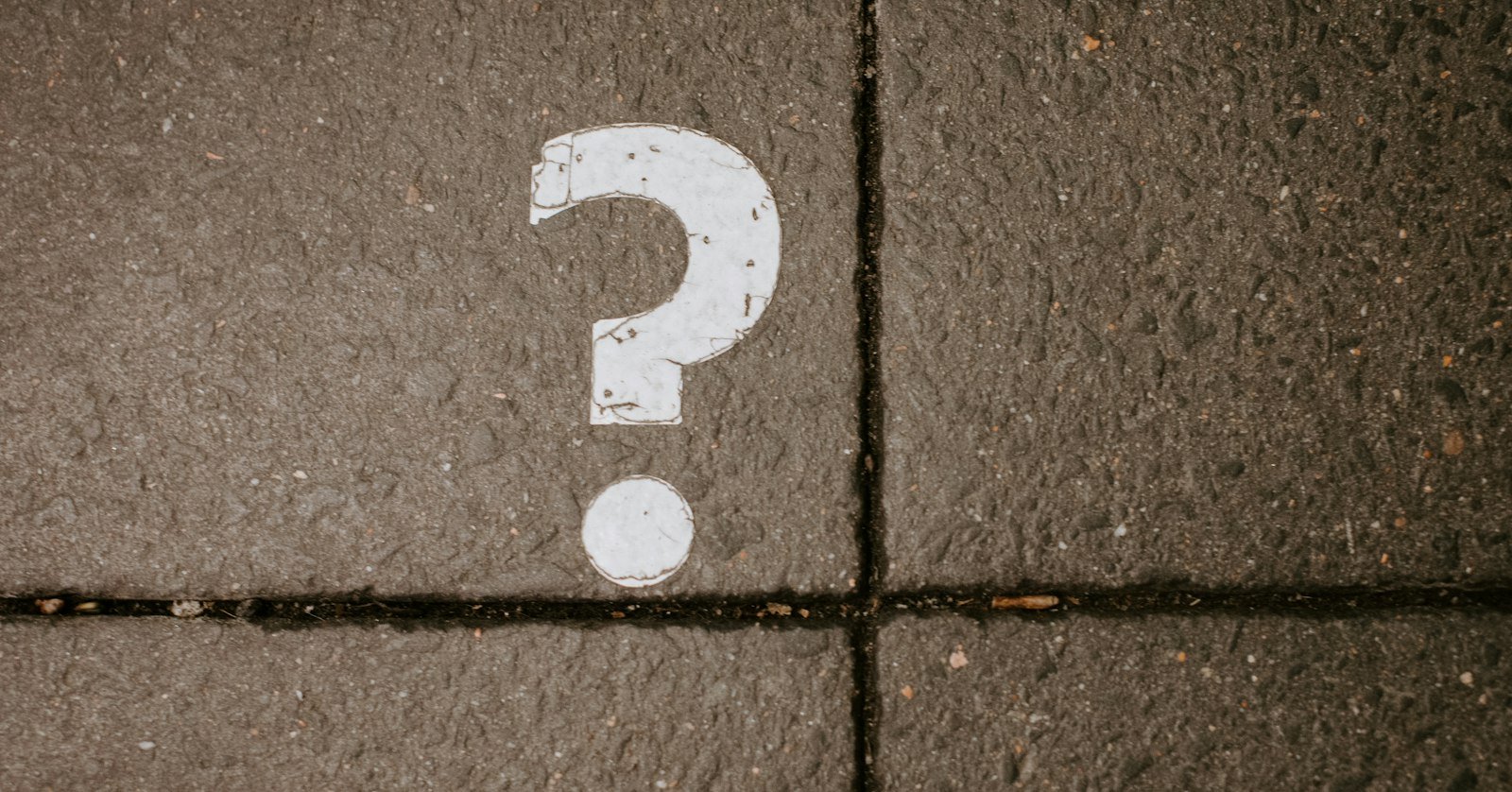 A question mark chalked on slate.