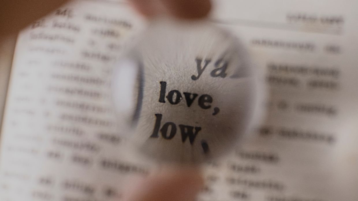 A magnifying glass over a line of printed text.