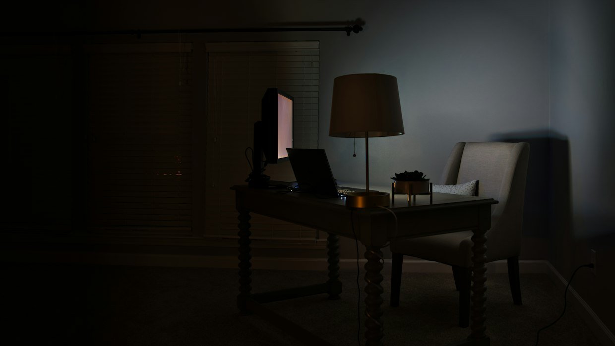 A blank screen glowing in a dark room.