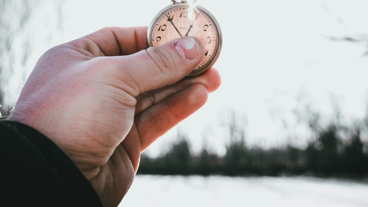 A stopwatch held up in one hand.