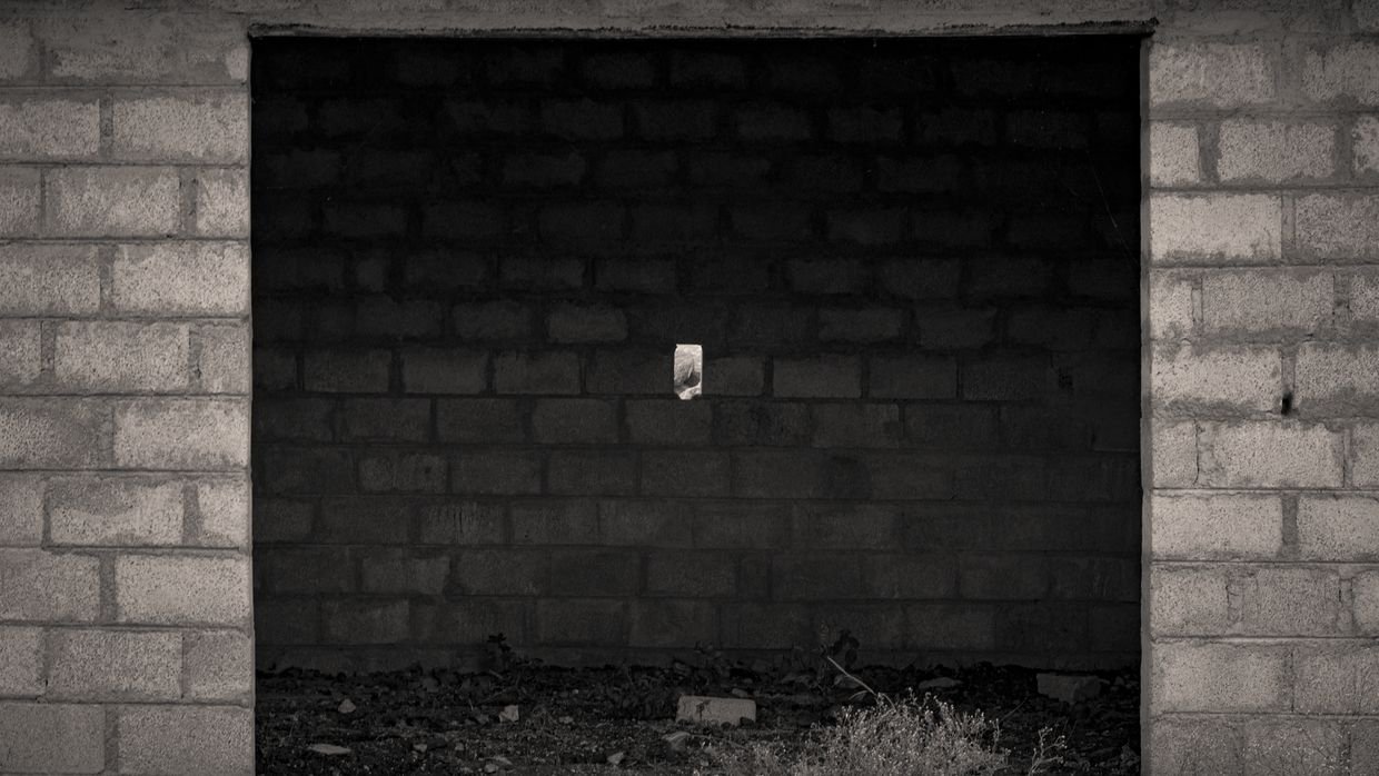 A brick wall with one gap in it.
