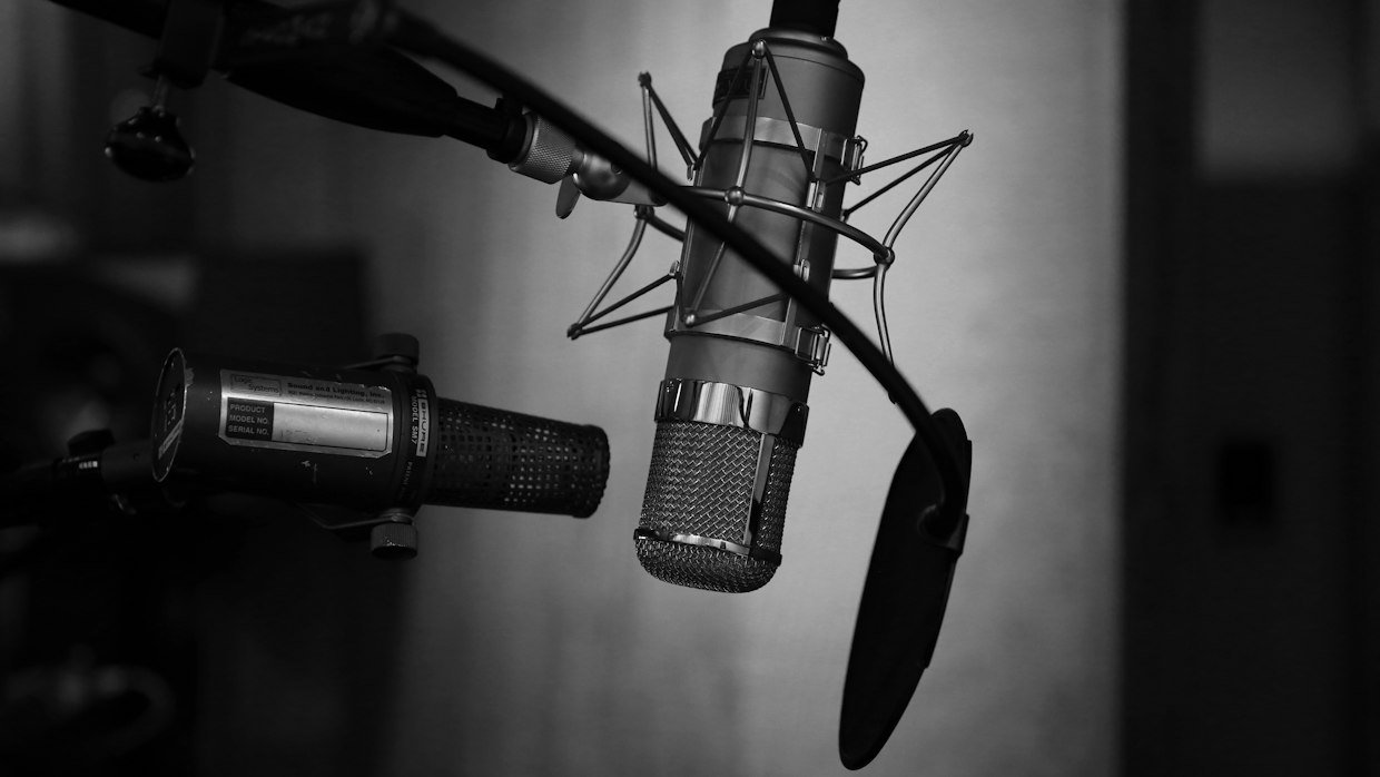 Two microphones facing one another across a table.