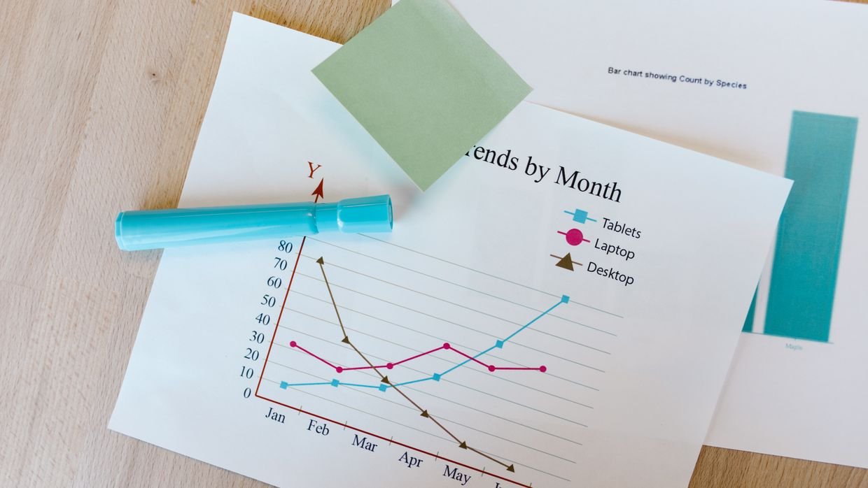 A printed comparison chart on a desk.