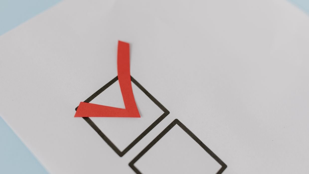 A hand ticking items on a checklist.