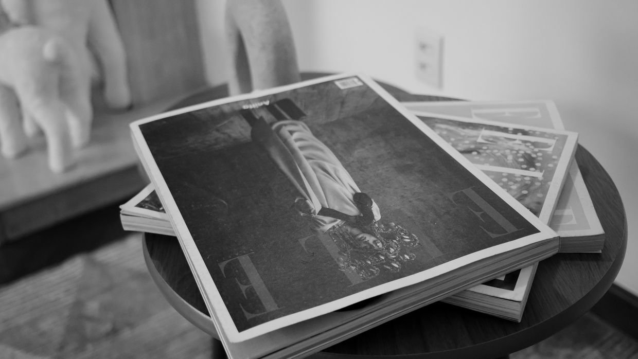A stack of magazines piled on a table.