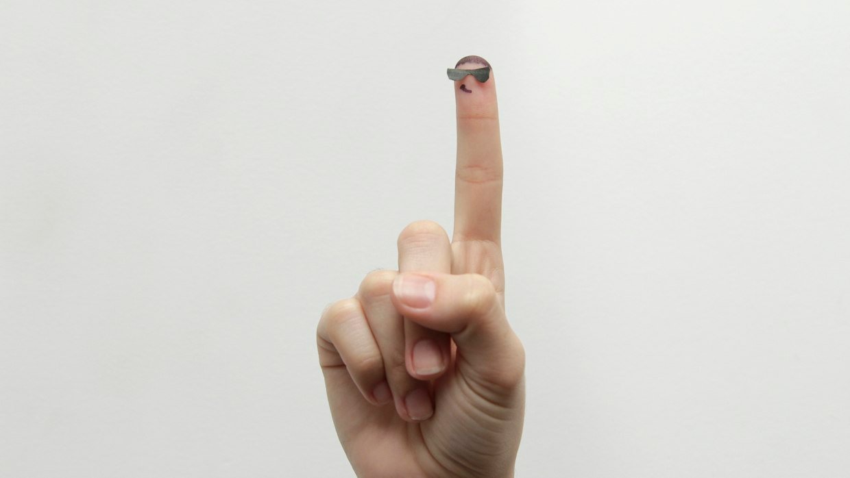 A finger pressing a single button.