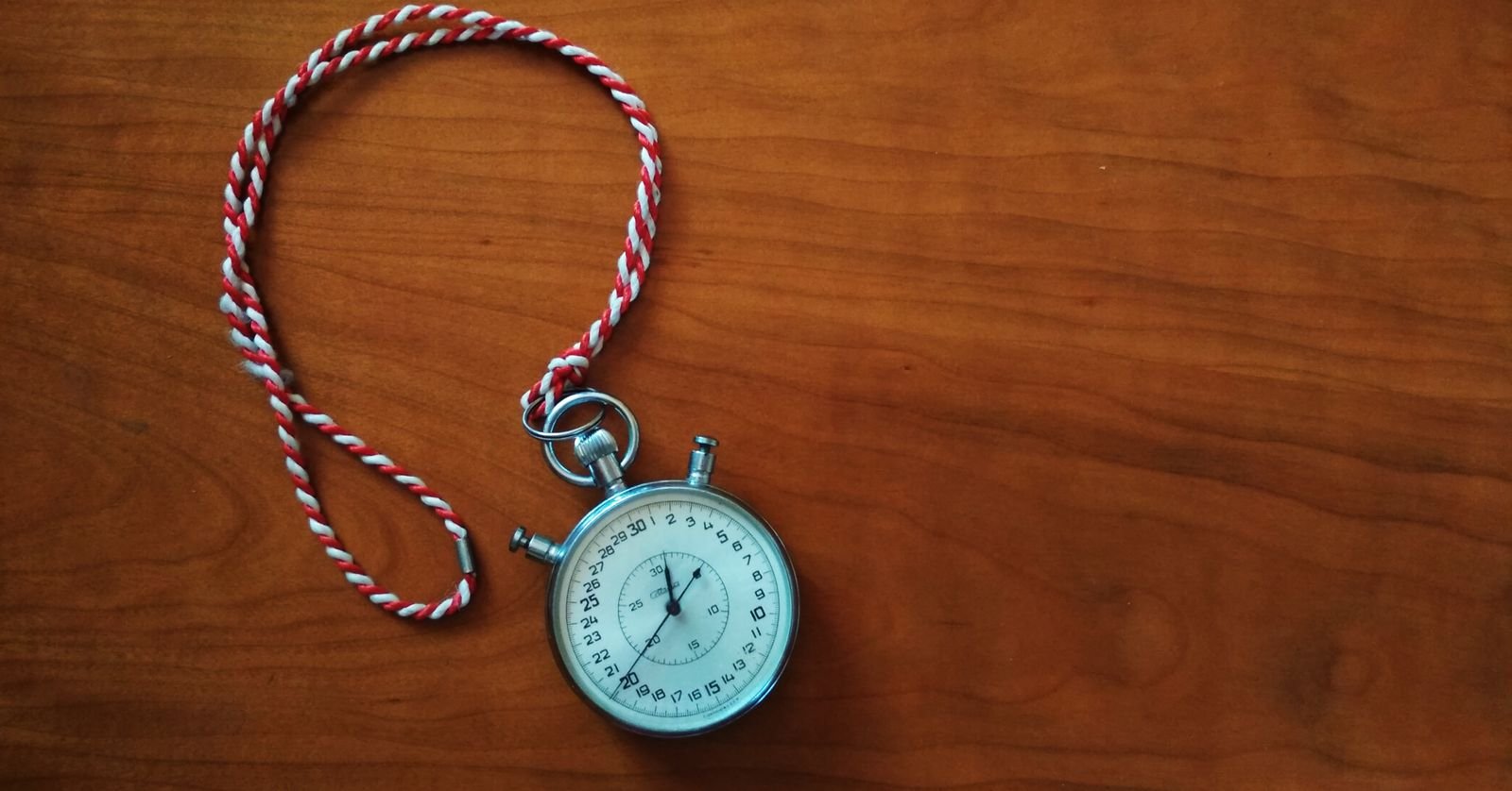 A stopwatch held against a plain background.