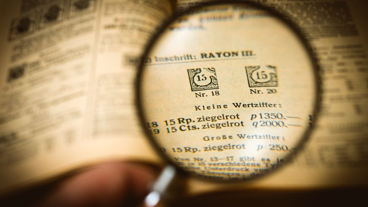 A magnifying glass held over a line of printed text.