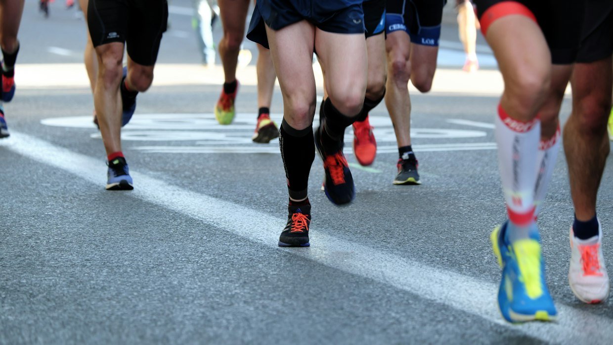 A relay baton passing from one runner to another.