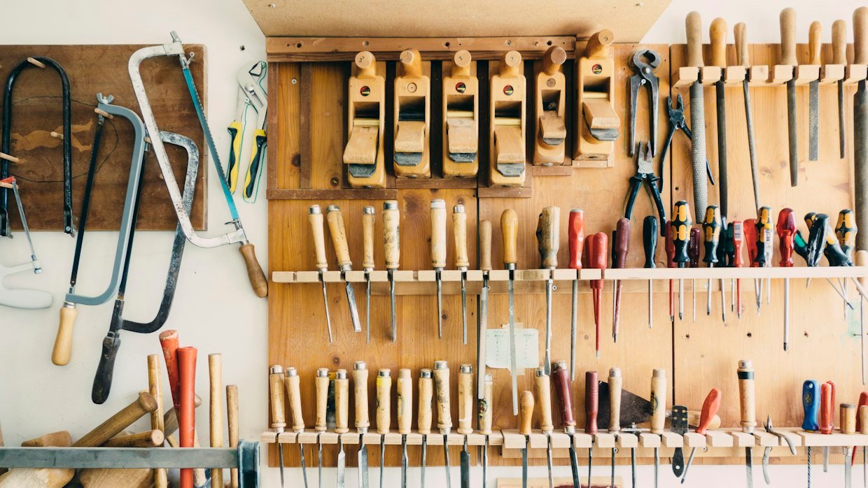 A workbench covered with well-used hand tools.