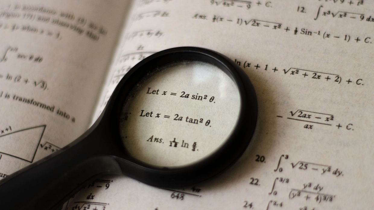 A magnifying glass over printed text, for checking a caption track for errors.