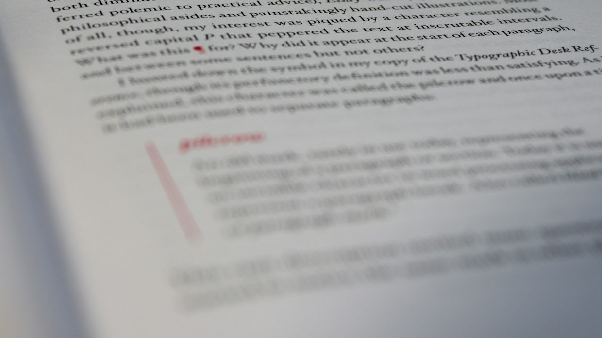 A page of text being corrected in red pen, like a creator editing automatic captions.