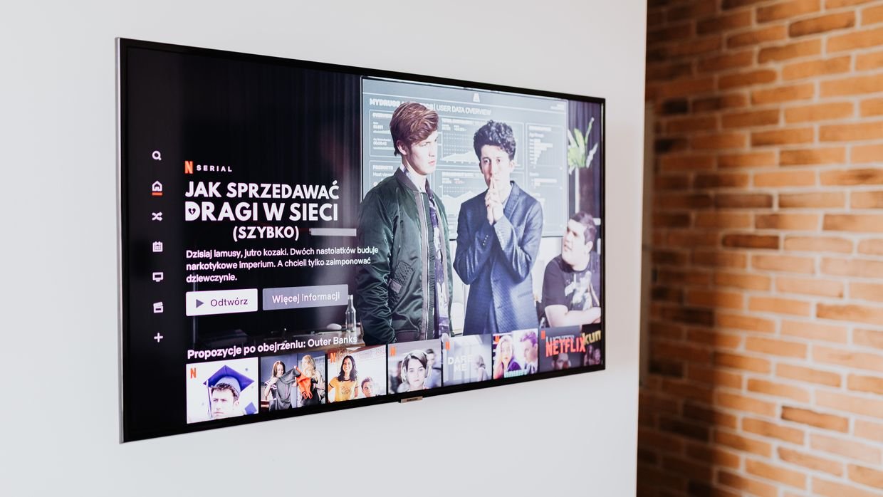 A video playing on a screen with subtitles showing, the sign a caption track exists.