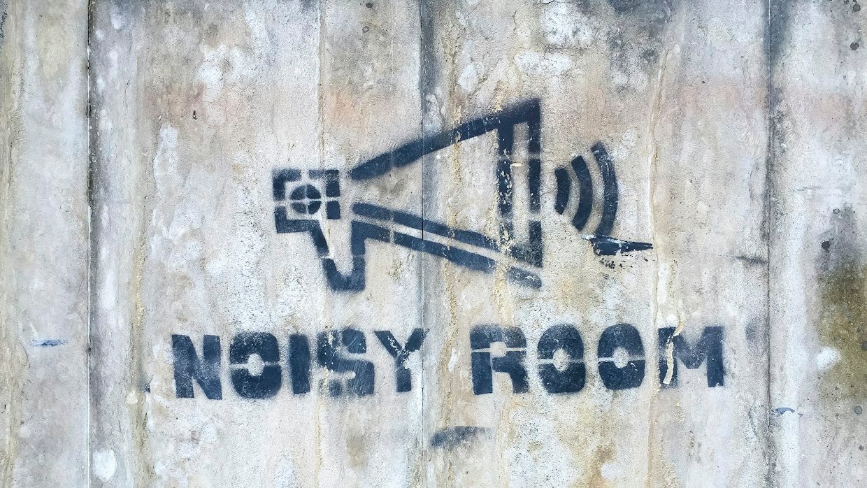 A microphone in a busy room, the kind of noisy audio that can stop automatic captions.