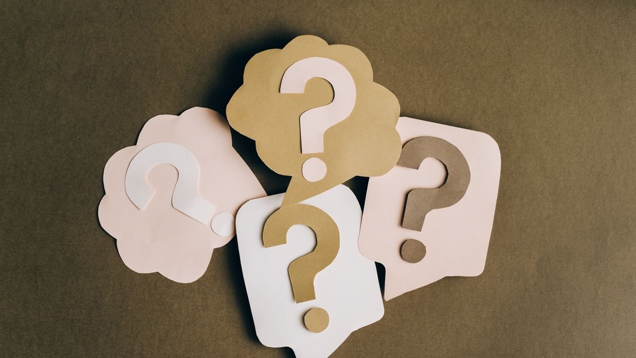 A question mark written on a sheet of paper.