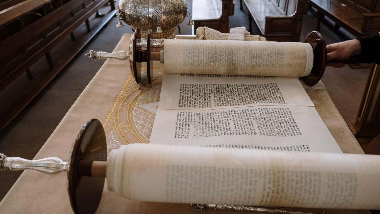 A long paper scroll unrolled across a floor.