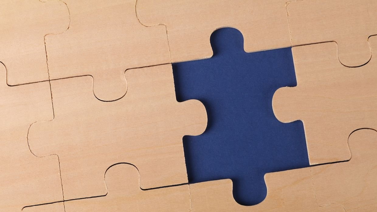 A jigsaw puzzle missing one piece.