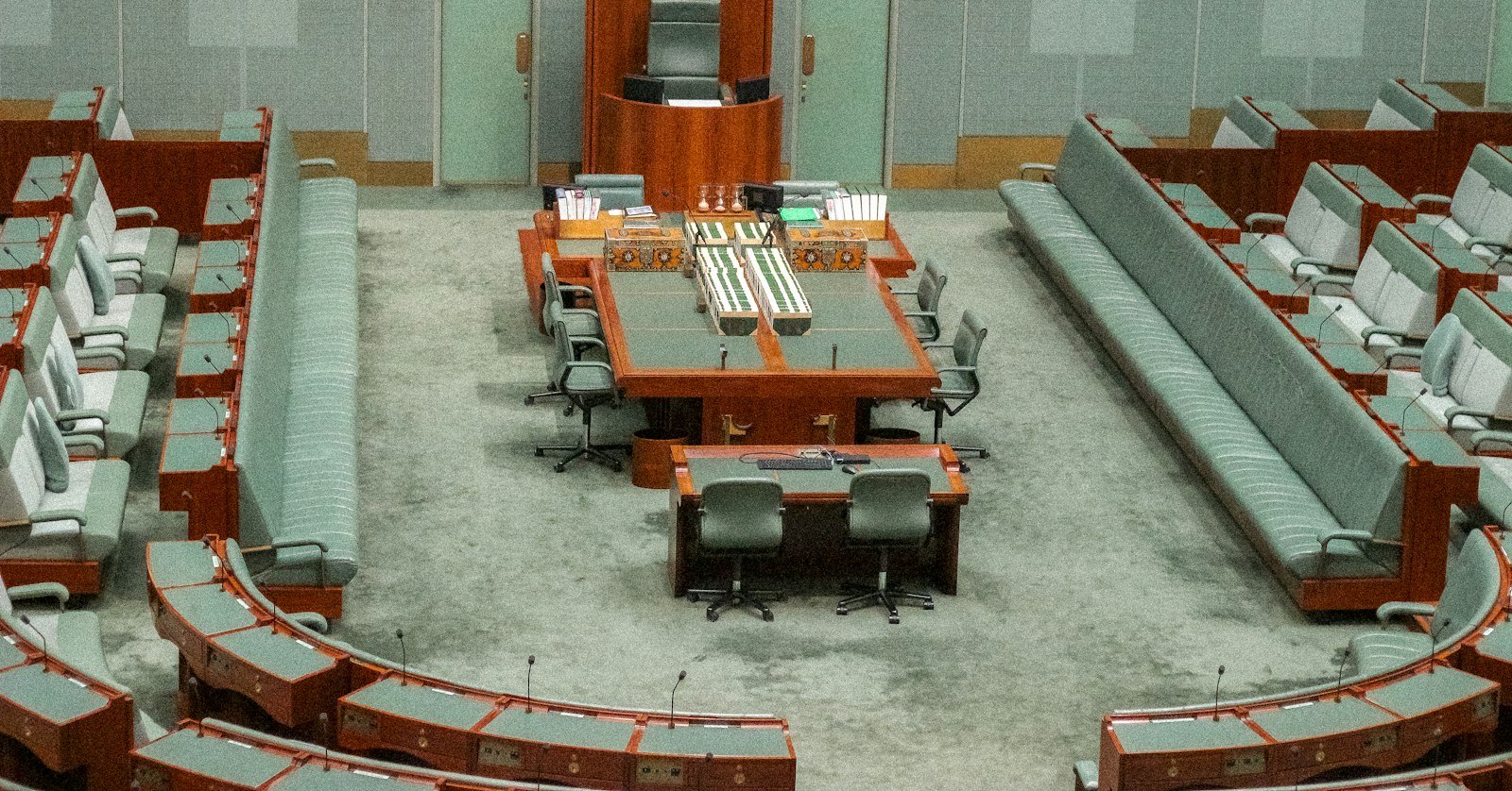 A council chamber with rows of empty seats.
