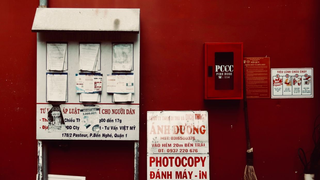 A noticeboard covered with public notices.