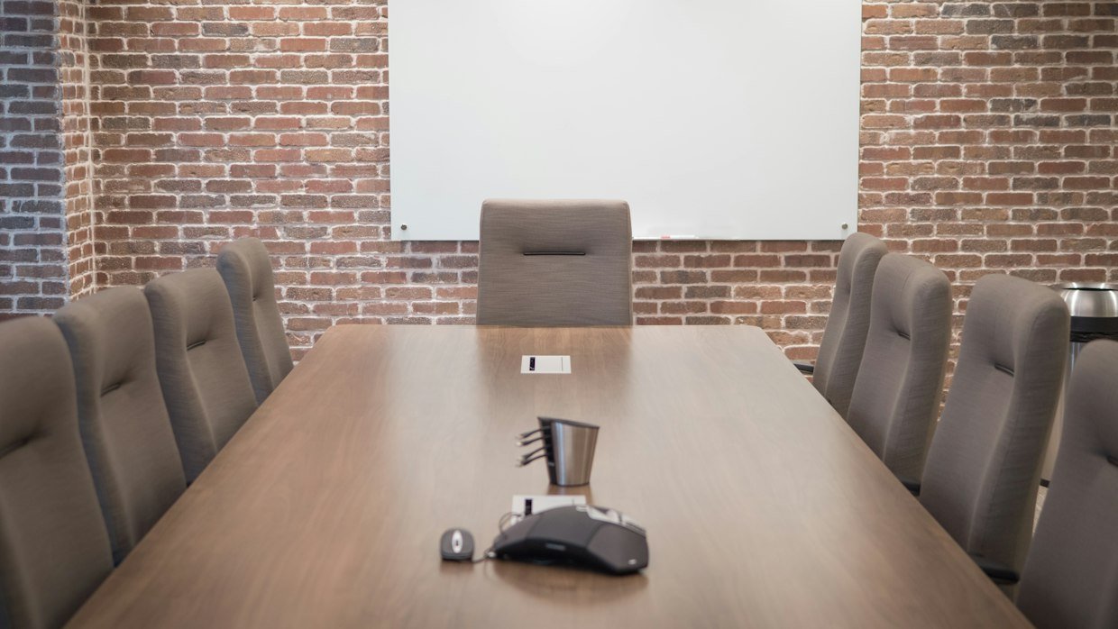 A microphone standing on a meeting table.