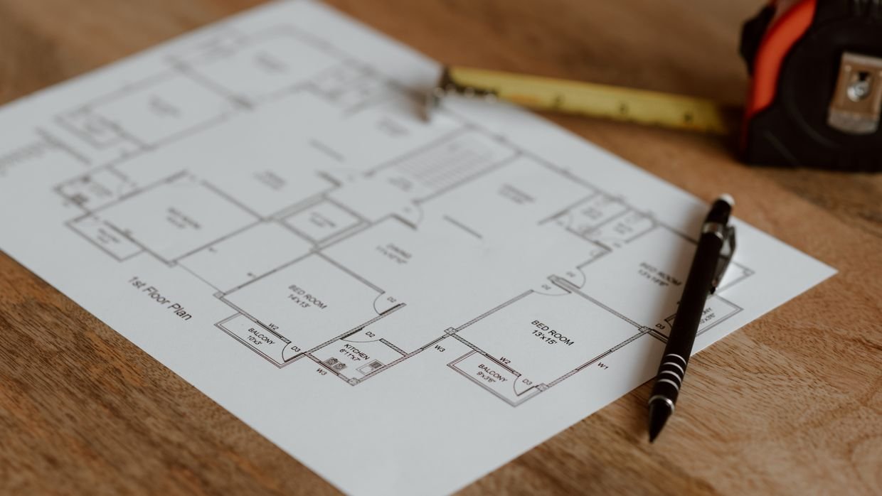 Planning drawings spread across a table.