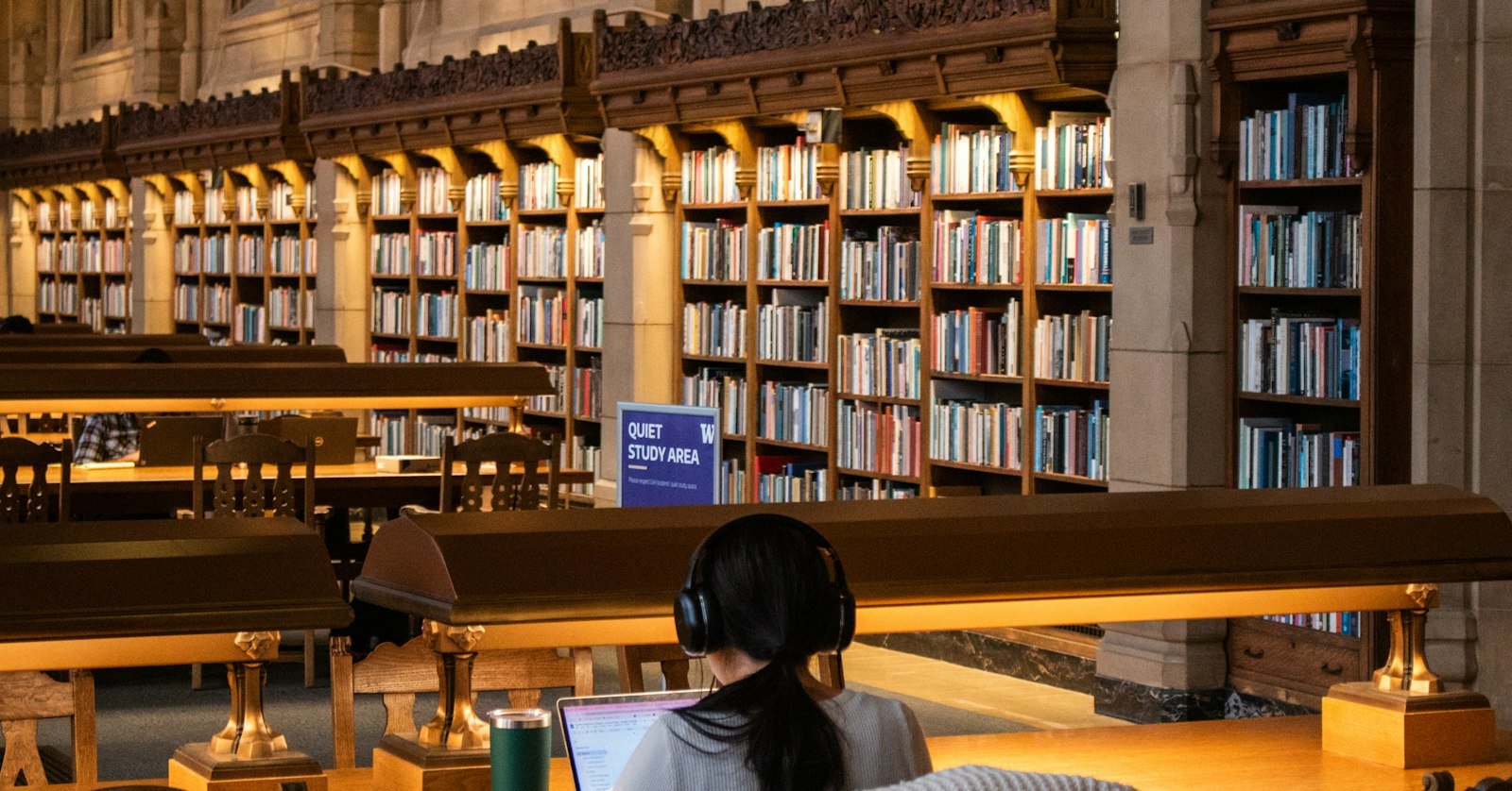 A person reading a long document on a laptop, as when pasting a transcript into Claude.