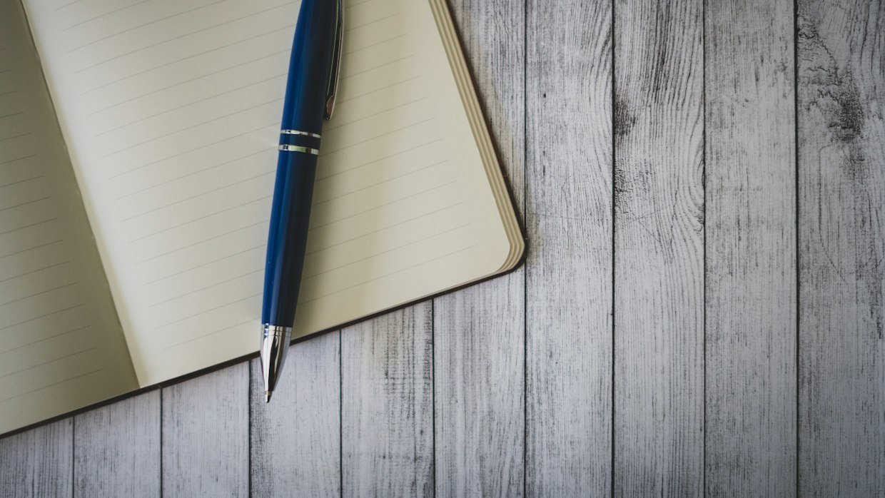 A notebook with handwritten questions, like the shaped requests that improve a summary.