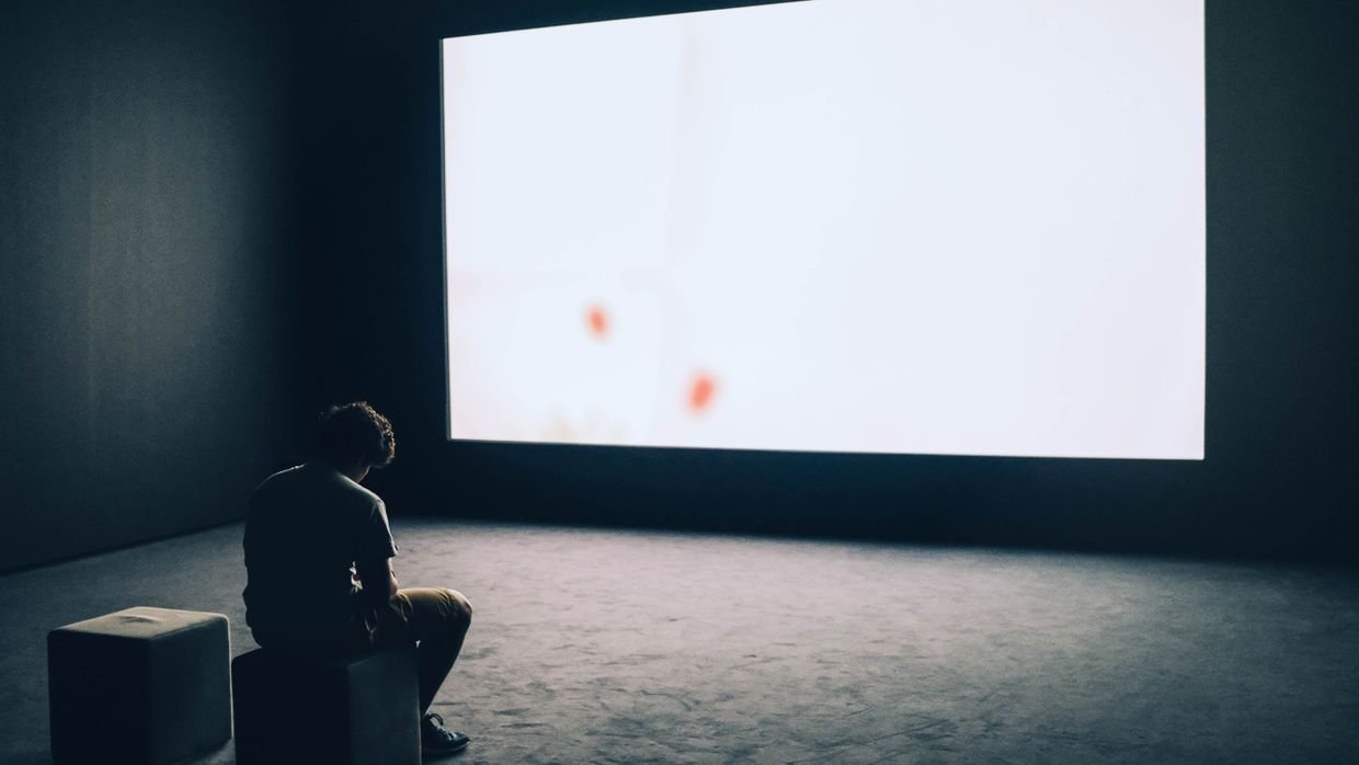 A blank monitor reflecting a darkened room.