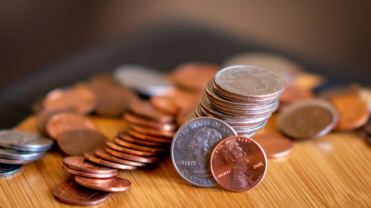 Loose coins and notes on a table.