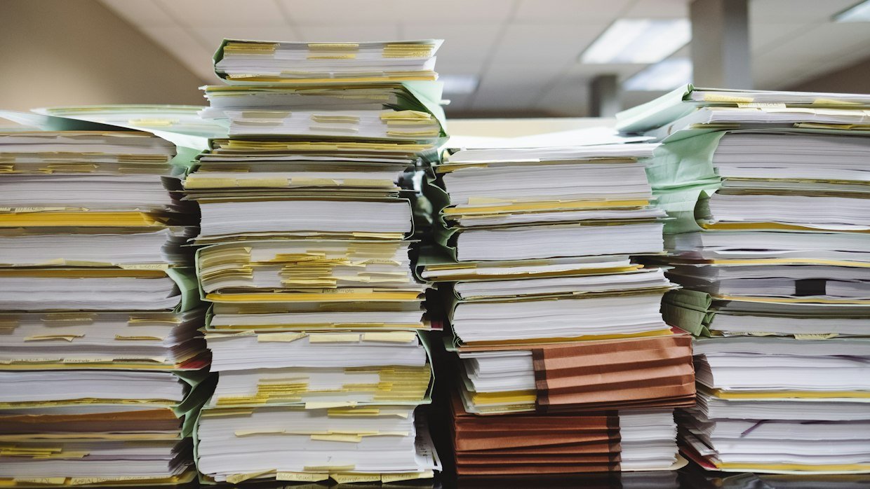 A stack of printed academic papers.