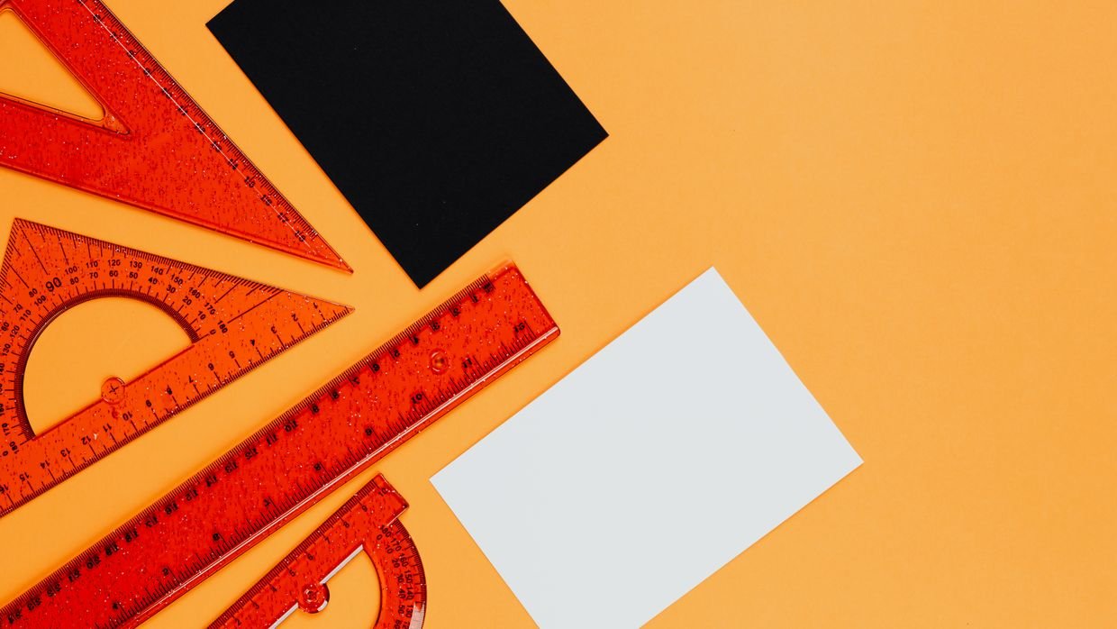 A ruler and measuring tools laid on paper.