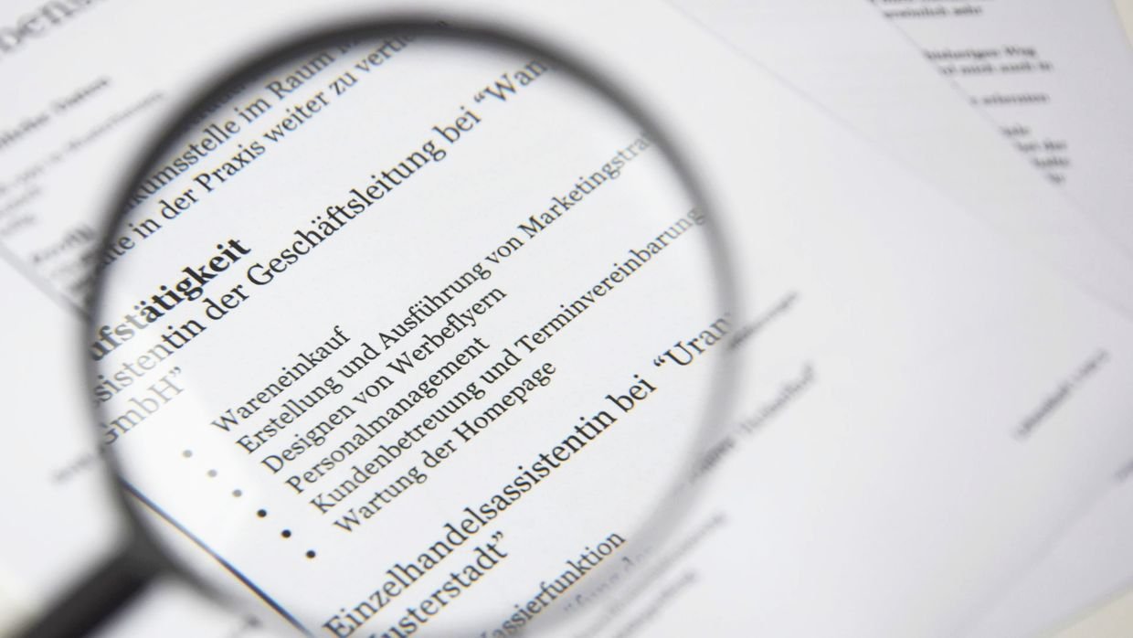 A magnifying glass held over small print.