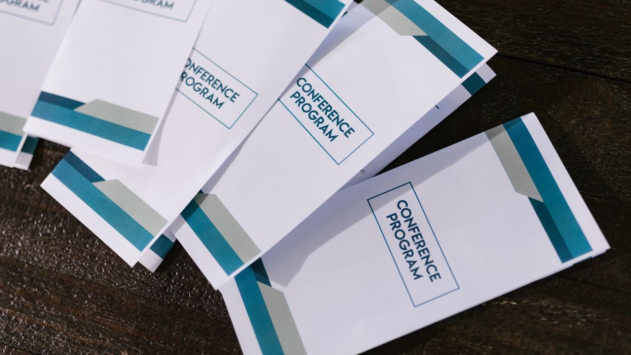 A printed event programme lying on a table.