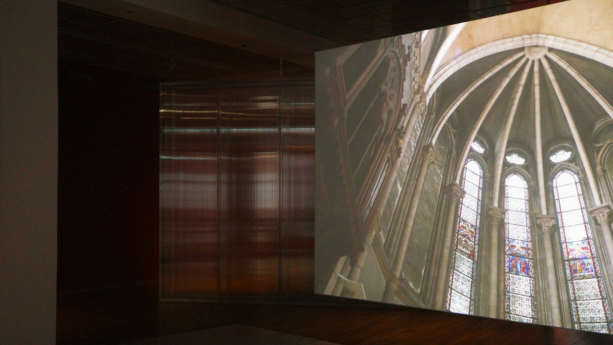 A projector screen displaying a chart in a darkened hall.
