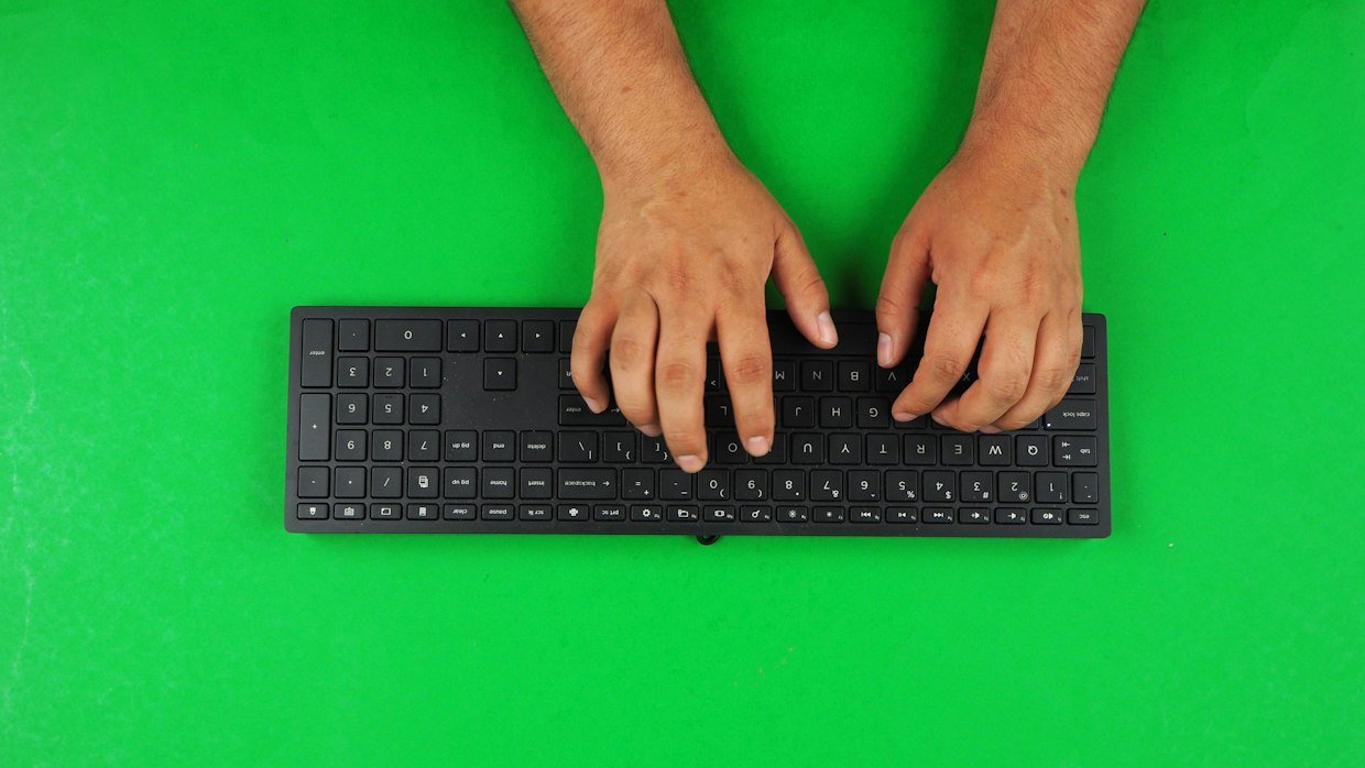 Hands typing quickly on a keyboard.