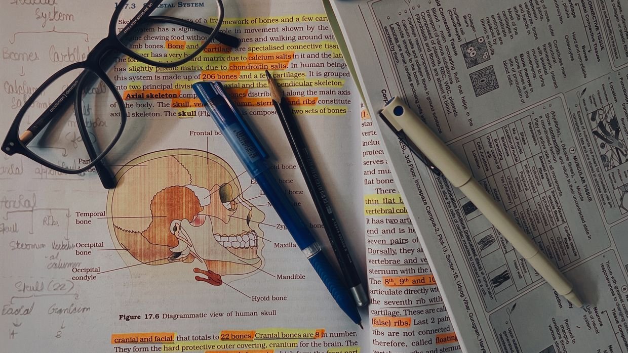 Handwritten notes next to a printed page, for comparing your summary with a generated one.