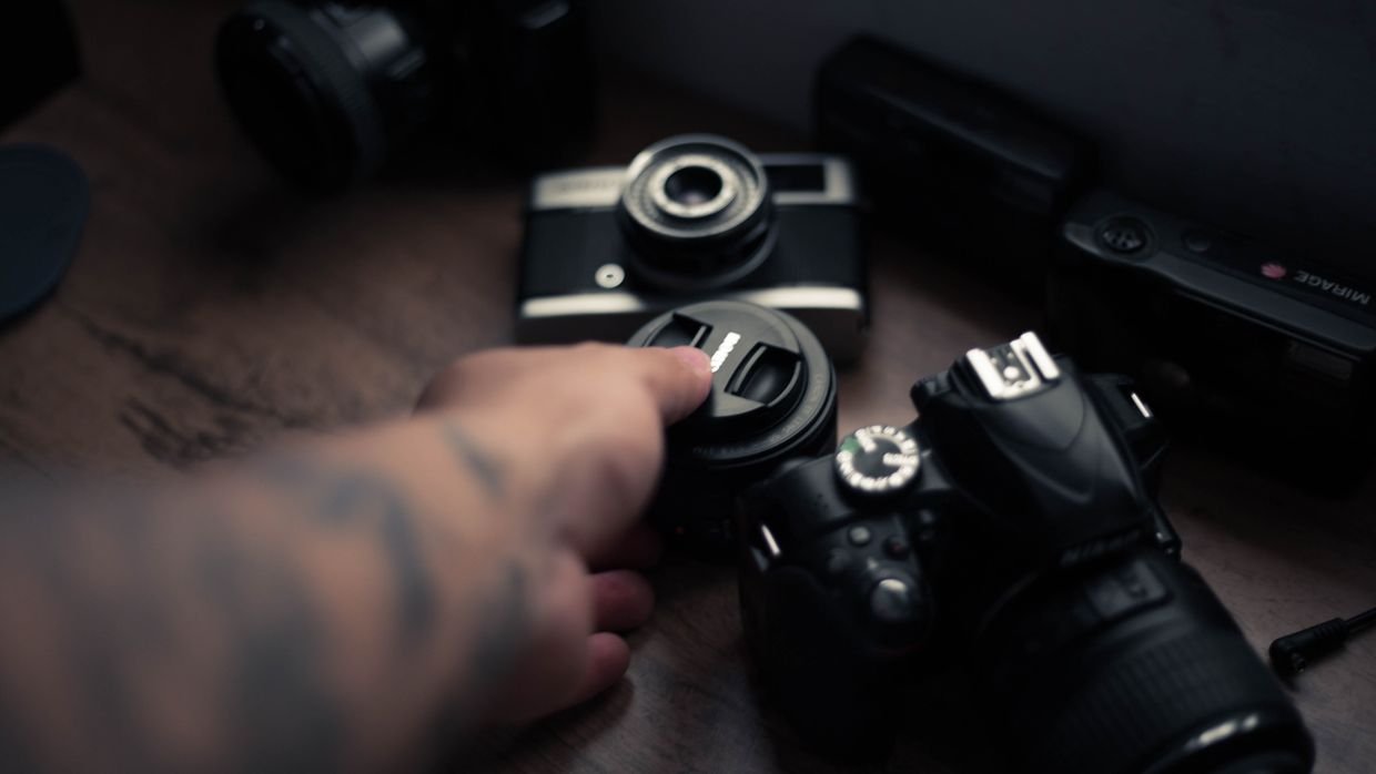 A lens cap resting beside a camera.