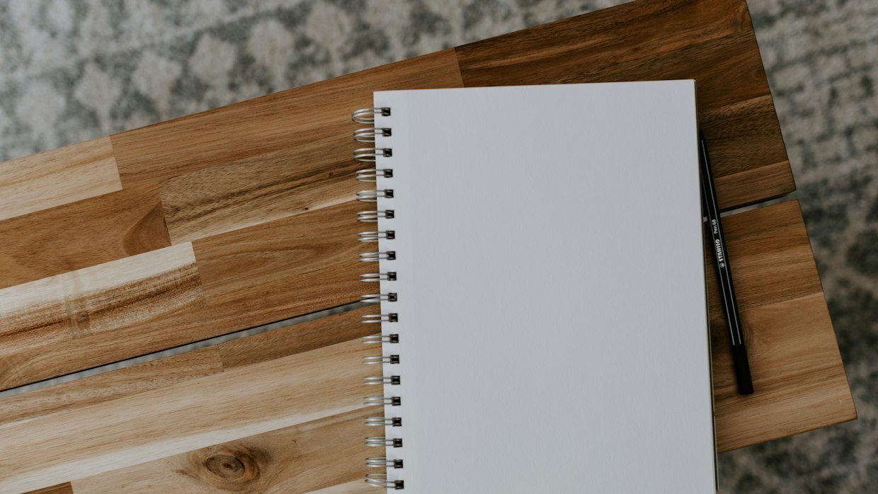 A notebook ruled into two columns, the format for listing each side’s claims by topic.