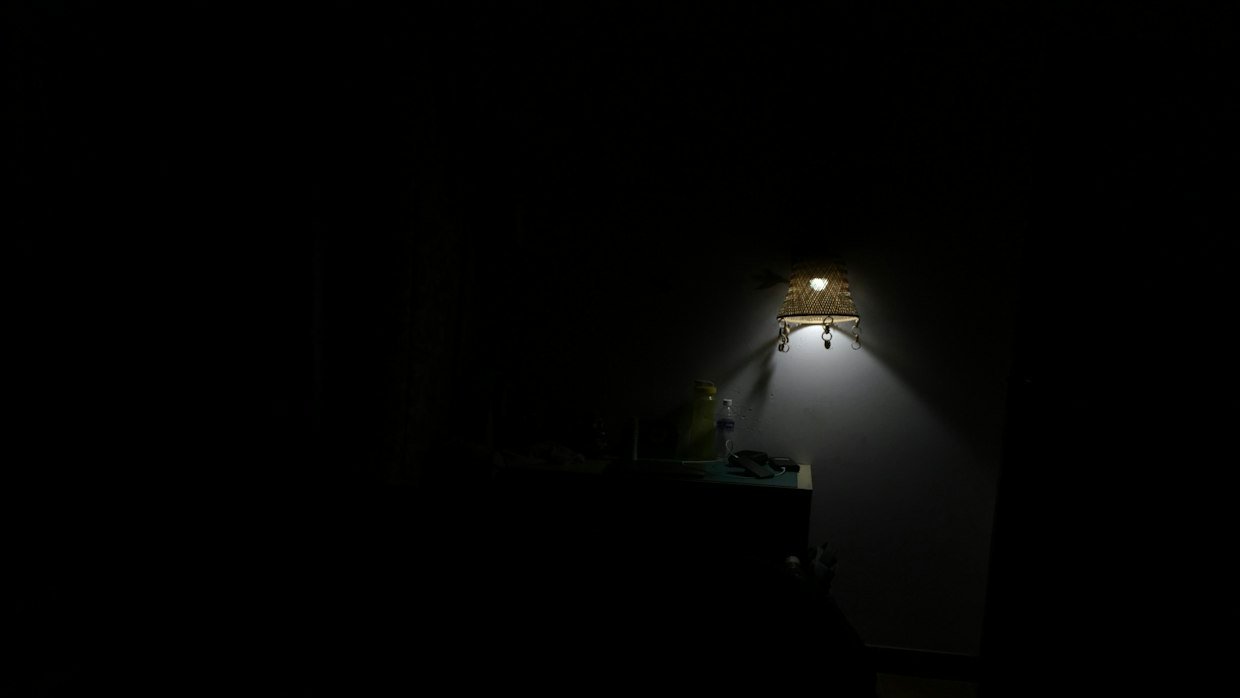 A projector beam cutting through a dark room.