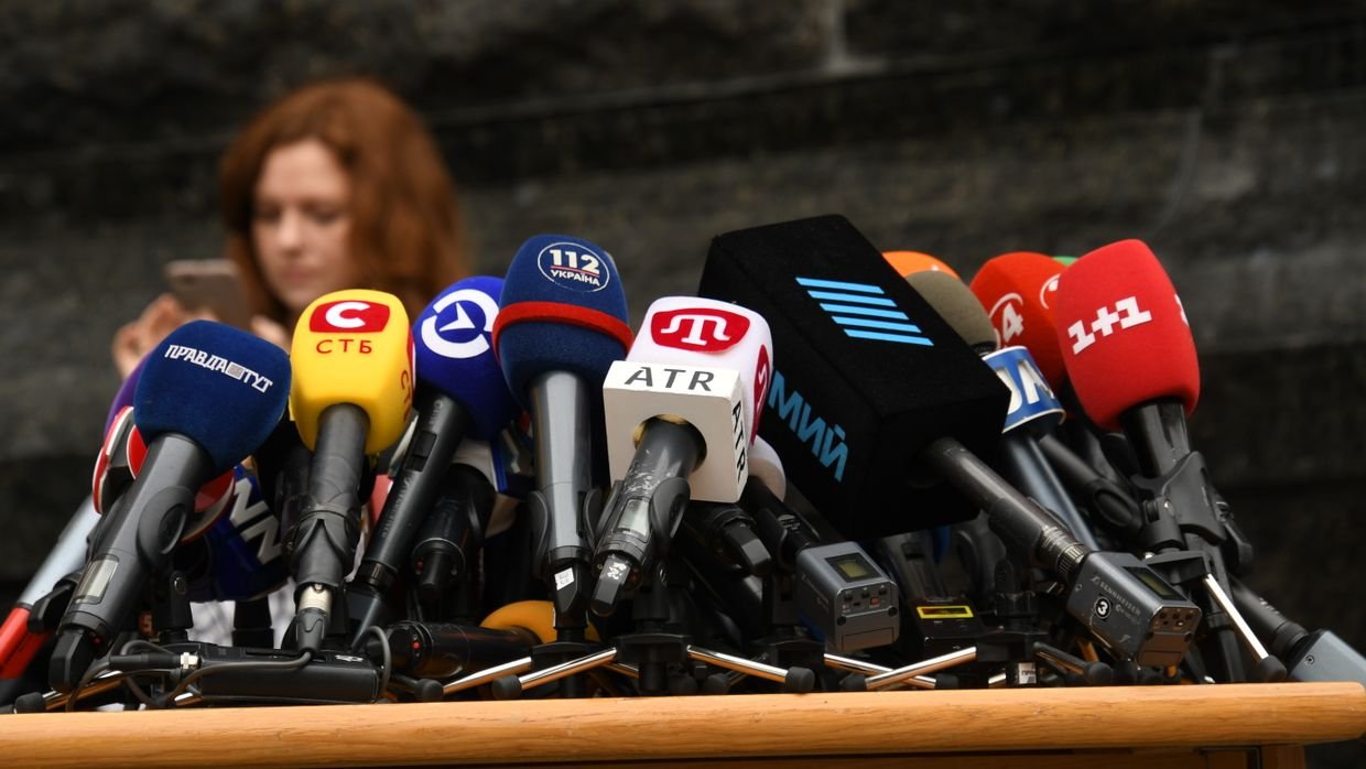 A microphone on a press conference table.