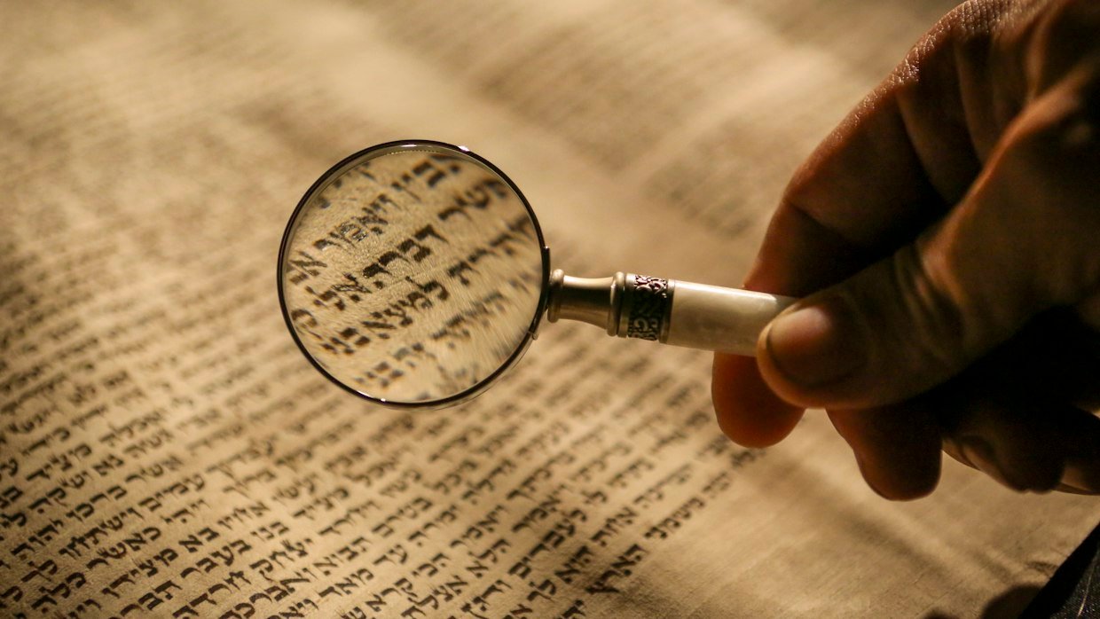 A magnifying glass held over printed text.
