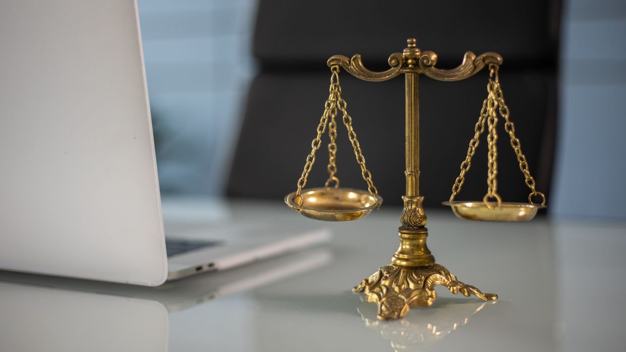 A set of balance scales on a desk.