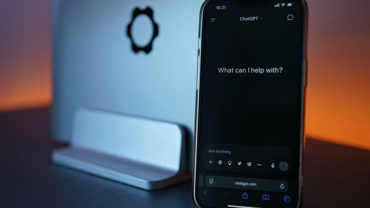 A phone beside a laptop, for Eightify’s extension plus iOS and Android apps.