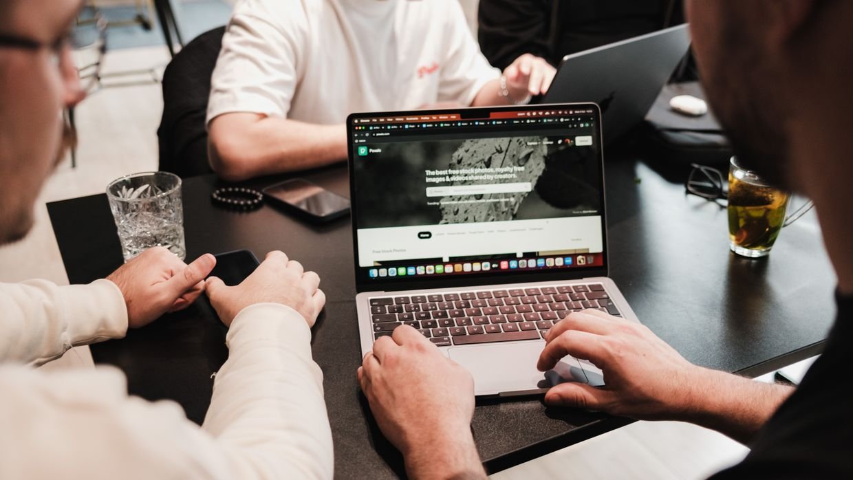 A laptop on a shared office desk, where installing an extension is often not allowed.